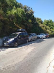 a row of cars parked on the side of a road at mare di zante "mare di levante" in Alikanas