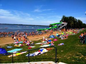 a large group of people on a beach at Tiszavirág Vendégház in Abádszalók
