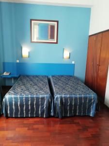 Giường trong phòng chung tại Residencial Chafariz /Queimada
