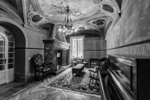 a living room with a fireplace and a chandelier at Mediterraneo Emotional Hotel & Spa in Santa Margherita Ligure