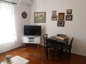 Una sala de estar con una mesa y un televisor. en apartman house Bjedov, en Povlja