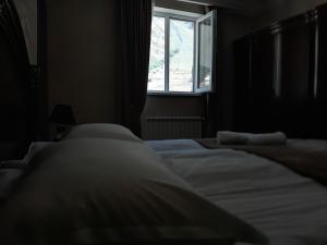 A bed or beds in a room at Kazbegi Guide
