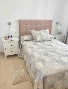 a bedroom with a large bed with two night stands at Apartamento Felisa in Arcos de la Frontera