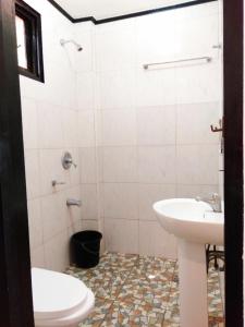 a bathroom with a sink and a toilet at Strangers Inn&Bar in General Luna