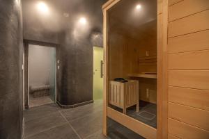 a hallway with a door leading to a room with a kitchen at Glyfada Riviera Hotel in Athens