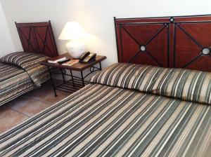 Postel nebo postele na pokoji v ubytování Citystate Asturias Hotel Palawan