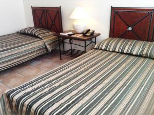 Postel nebo postele na pokoji v ubytování Citystate Asturias Hotel Palawan