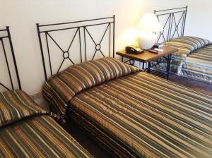 Postel nebo postele na pokoji v ubytování Citystate Asturias Hotel Palawan