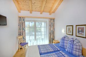 a bedroom with a bed and a window at Haus Seifriedsberger in Bramberg am Wildkogel