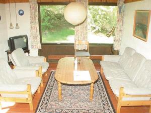 Oddeにある6 person holiday home in Hadsundのリビングルーム(白いソファ、コーヒーテーブル付)
