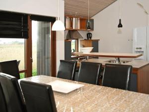 a kitchen and dining room with a table and chairs at 8 person holiday home in Ulfborg in Thorsminde