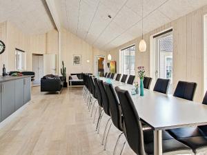 a dining room with a long table and chairs at 20 person holiday home in Hasselberg in Kappeln