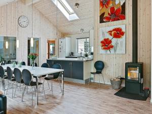 a kitchen and dining room with a table and chairs at 16 person holiday home in Dronningm lle in Gilleleje