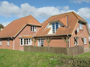a brick house with a red roof at 14 person holiday home in Bl vand in Ho