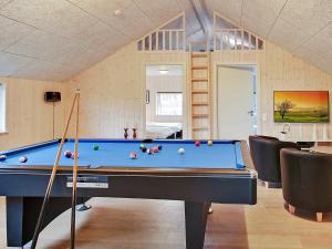 a room with a pool table in a room at 12 person holiday home in Hasselberg in Kappeln