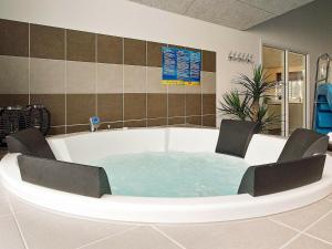 a bath tub with two chairs sitting in it at 16 person holiday home in Hasselberg in Kappeln