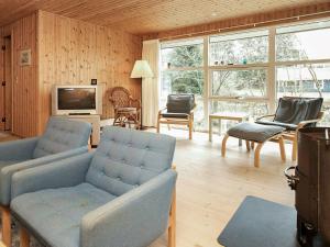 a living room with two couches and a tv at 6 person holiday home in Hals in Hals