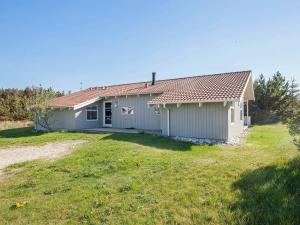 a house with a large yard in front of it at 10 person holiday home in Thisted in Klitmøller