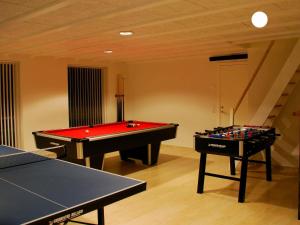 two ping pong tables in a living room with at 18 person holiday home in Løkken-By Traum in Løkken