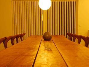 a long wooden table with two wine glasses on it at 18 person holiday home in Løkken-By Traum in Løkken +23 photos