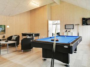 a ping pong table in a room with a pool table at 18 person holiday home in Hasselberg in Kappeln
