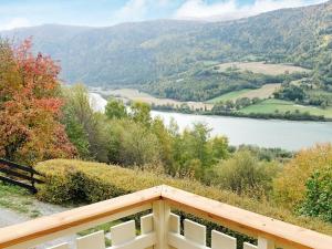 a balcony with a view of a river and mountains at 6 person holiday home in Otta in Otta