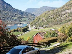 a car parked on a road next to a mountain at 6 person holiday home in Otta in Otta