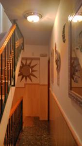 a hallway with a staircase with a star on the wall at Pensión El Hidalgo in Granada