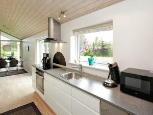 a kitchen with a sink and a window at 6 person holiday home in Jerup in Jerup