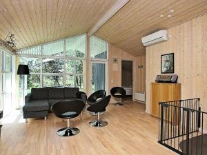 uma sala de estar com cadeiras pretas e um sofá em 10 person holiday home in Fjerritslev em Torup Strand