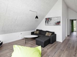 a living room with a couch and a table at 8 person holiday home in R m in Rømø Kirkeby