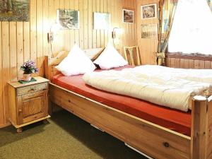 a bedroom with a large bed with a wooden frame at Two-Bedroom Holiday home in Ulfborg 4 in Sønder Nissum