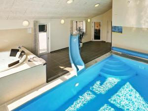 a swimming pool with a slide in a house at Eight-Bedroom Holiday home in Frederiksværk in Melby