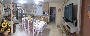 a dining room with a table and a tv in a kitchen at Pousada Temporada Familiar in Urubici