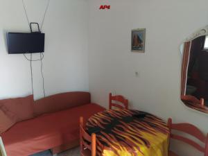 a living room with a couch and a bed at Apartments Šudić in Njivice