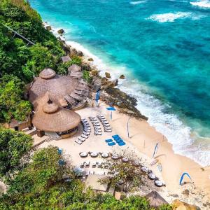 an aerial view of a beach with chairs and umbrellas at Jasmina Estate in Seminyak