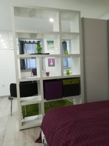 a bedroom with a desk and a computer in a mirror at DRENO Apartman in Zagreb