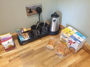 a counter with food and a coffee maker and snacks at Open Acres Accommodation in Bristol