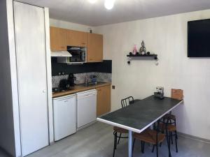 a small kitchen with a table and a counter top at Résidence Bellevue in Cauterets