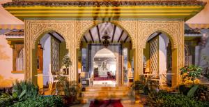 an ornate hallway in a building with plants at Hotel Tarek in Chefchaouen