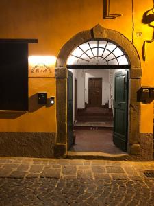 an entrance to a building with a green door at Alloggi per uso turistico A&M in Acquapendente +16 photos