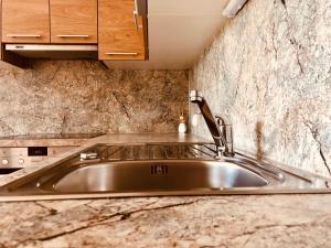 a stainless steel kitchen sink with a faucet at Ferienhof Hintergrabenbauer in Spital am Pyhrn