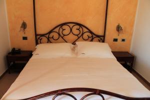 a bed with two white pillows on it at Hotel Medusa in Lampedusa