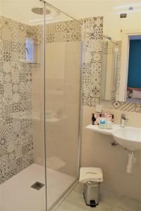 a bathroom with a shower and a toilet and a sink at Hotel Medusa in Lampedusa