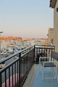 a balcony with a view of a marina at Hotel Medusa in Lampedusa