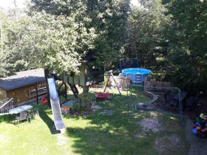 a backyard with a play yard with a playground at Haus Waldesruh, 3 Ferienwohnungen in Hemfurth-Edersee