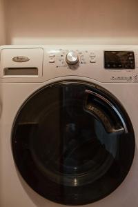 a close up of a washing machine with a window at Montana Apartment City Center in Braşov