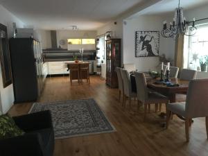 a kitchen and dining room with a table and chairs at Öregrund BnB in Öregrund