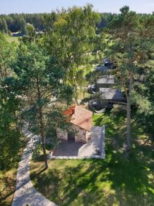 an overhead view of a house with trees and a driveway at Camping Noras in Mērsrags