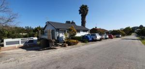 a house with cars parked on the side of a street at Knys-to-stay in Knysna